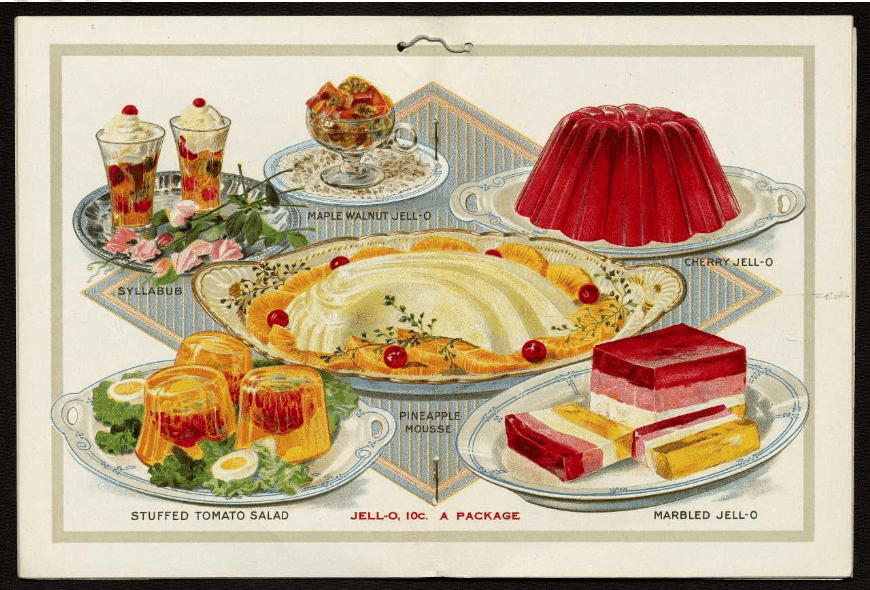 Colourful desserts including fruit parfaits, a jelly mould, and layered gelatine cakes on decorative plates