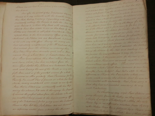 Two open pages of a vintage handwritten journal with cursive writing.