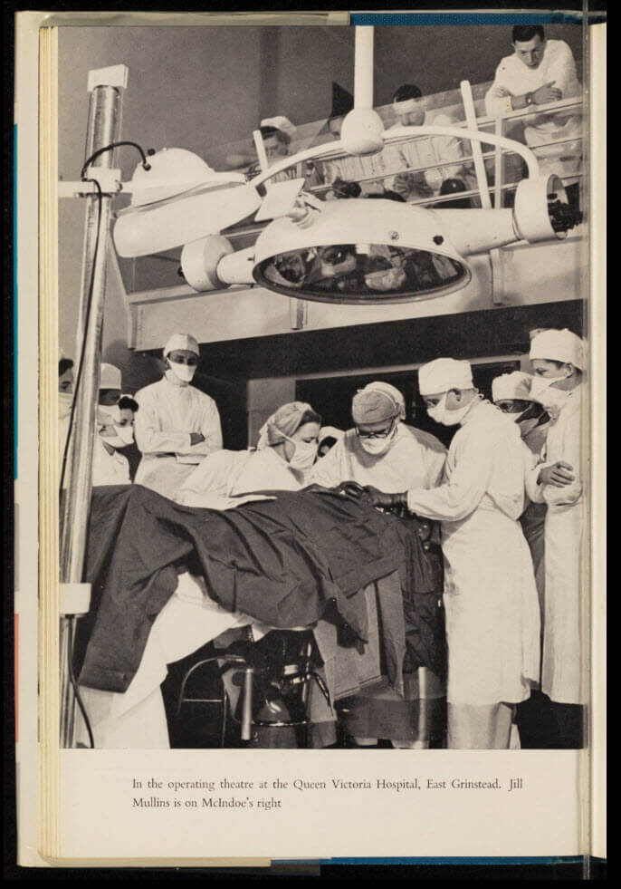 A surgical team performs an operation in an operating room, with surgeons and nurses in scrubs