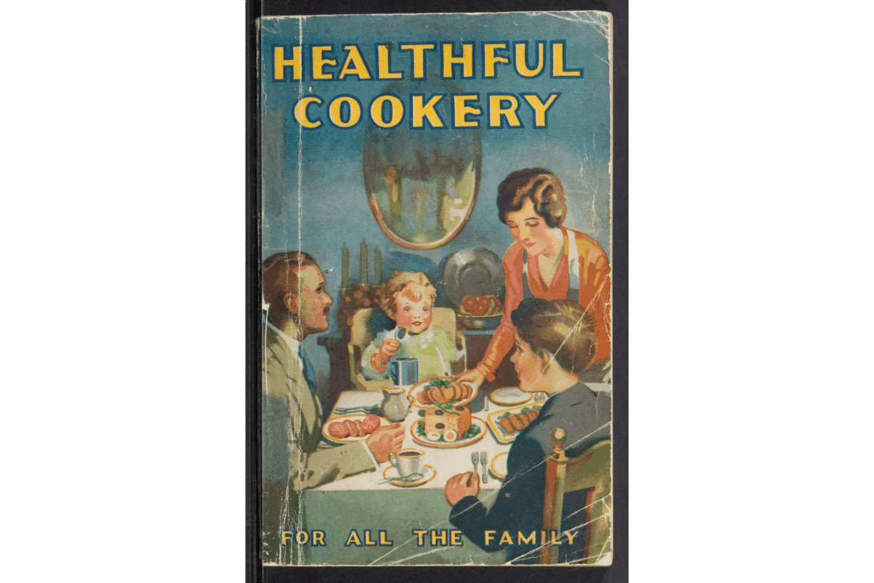 A vintage cookbook titled 'Healthful Cookery' with a family enjoying a meal at a dining table
