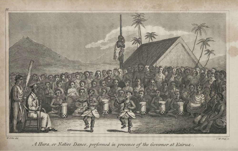 A traditional dance performance in front of a crowd, featuring drummers and a dancer in costume.