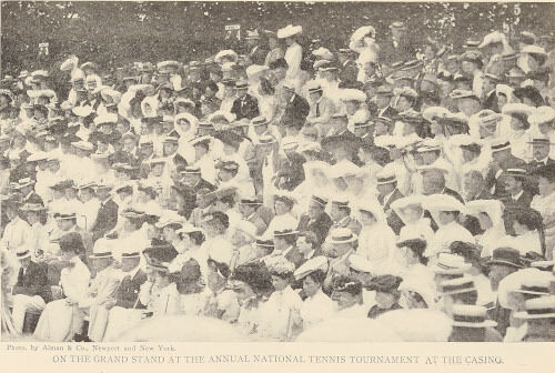A large crowd of people, mostly women in hats, seated outdoors for an event
