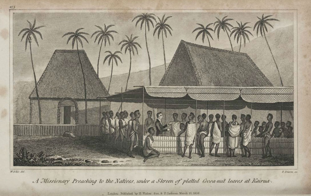 A missionary speaking to a group of people under a tent made of coconut leaves, with huts and palm trees around.