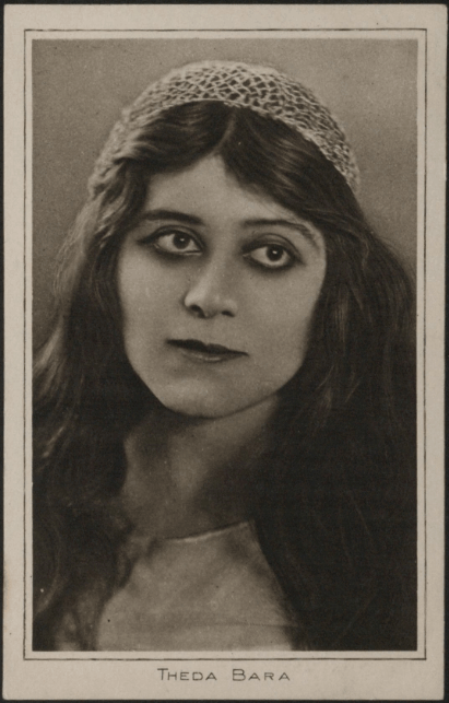 A black and white portrait of a woman with long dark hair and a headband, looking directly at the camera