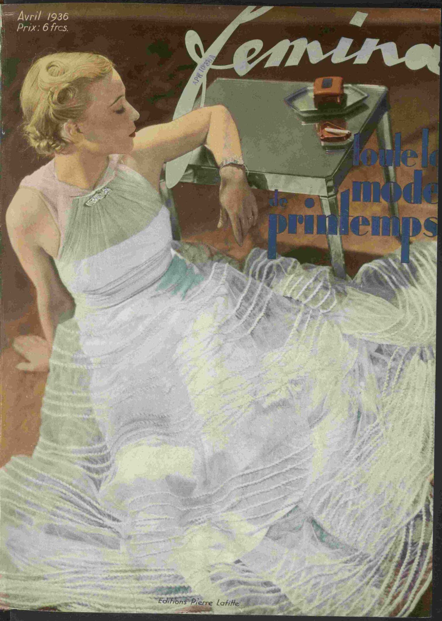 A woman in a white dress sitting at a table with a drink, featured on a vintage magazine cover