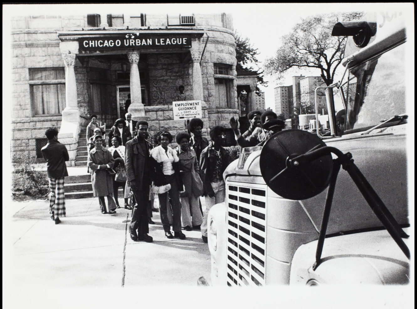 A group of people outside the 'Chicago Urban League' building.