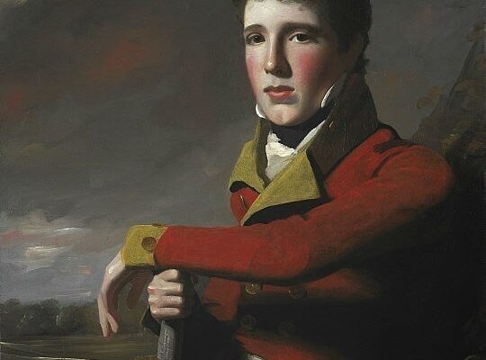 A young boy wearing a red military coat, resting his arm on a sword, with a cloudy background.