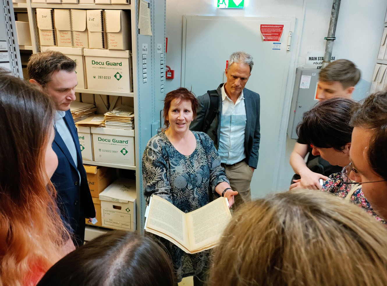 Archivist showing a manuscript to other archivists at Ukrainian Archival Summer School