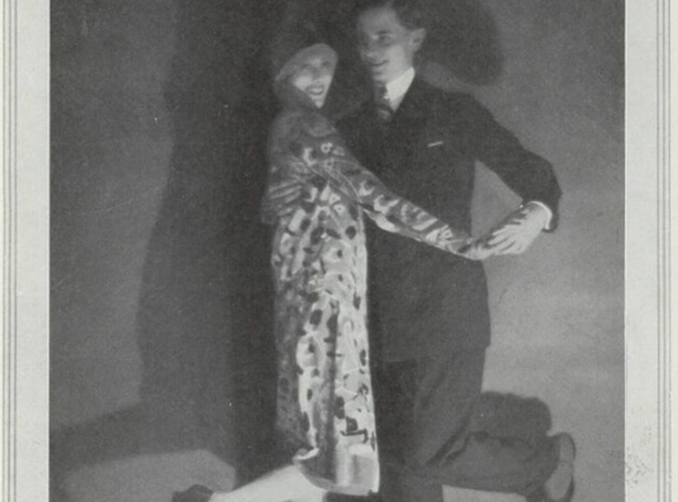 A couple dressed in 1920s fashion, dancing.