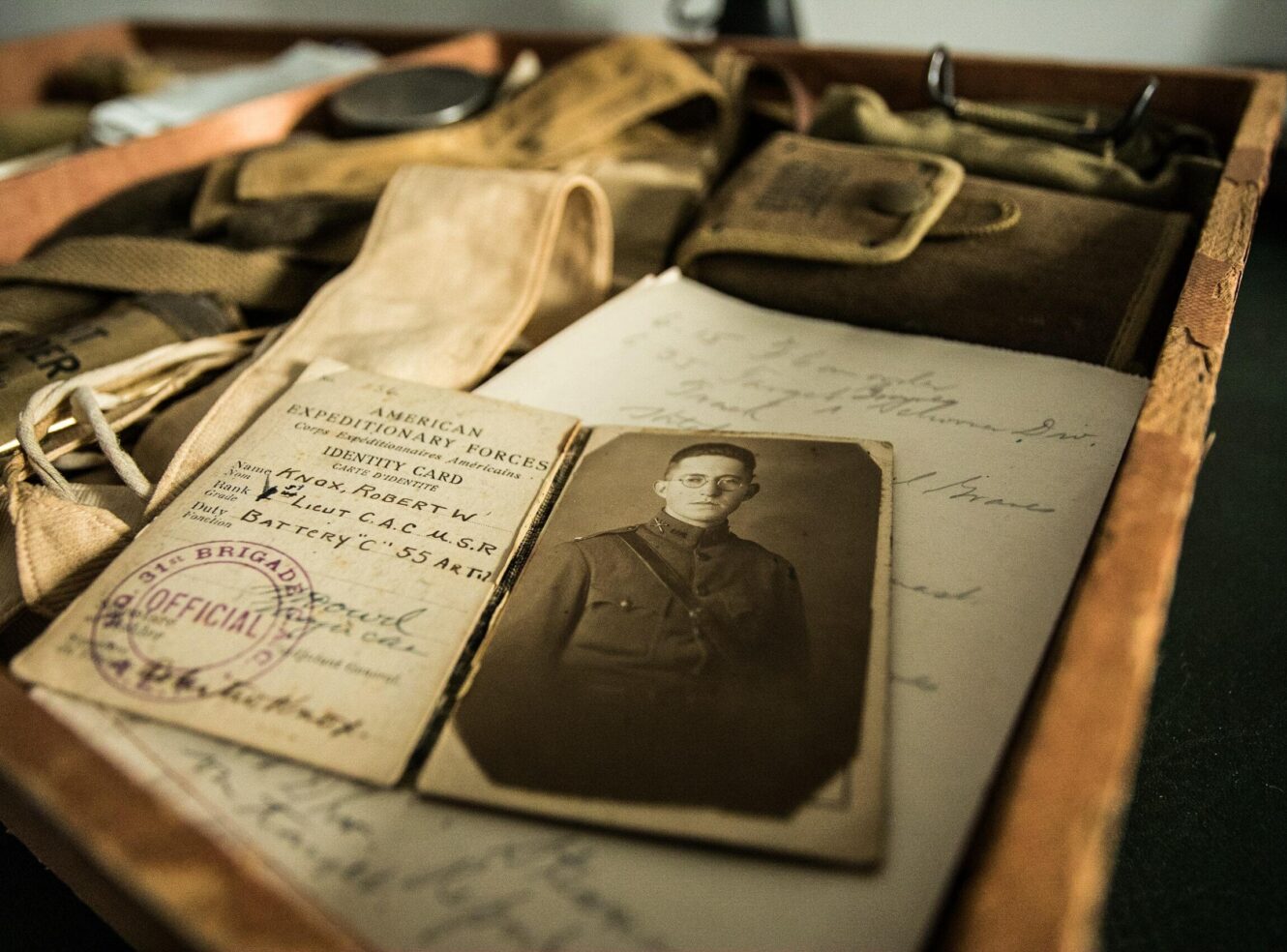 Old wooden box containing a soldier's ID card and a black-and-white photo of the soldier.
