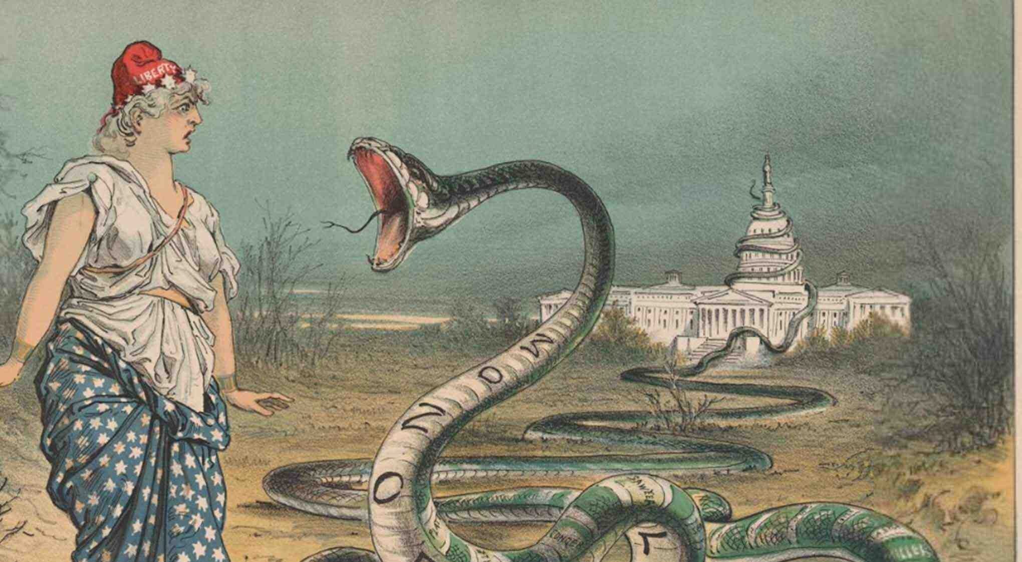A woman reacts to a large snake with 'MONOPOLY' on its underbelly as a man and child watch.